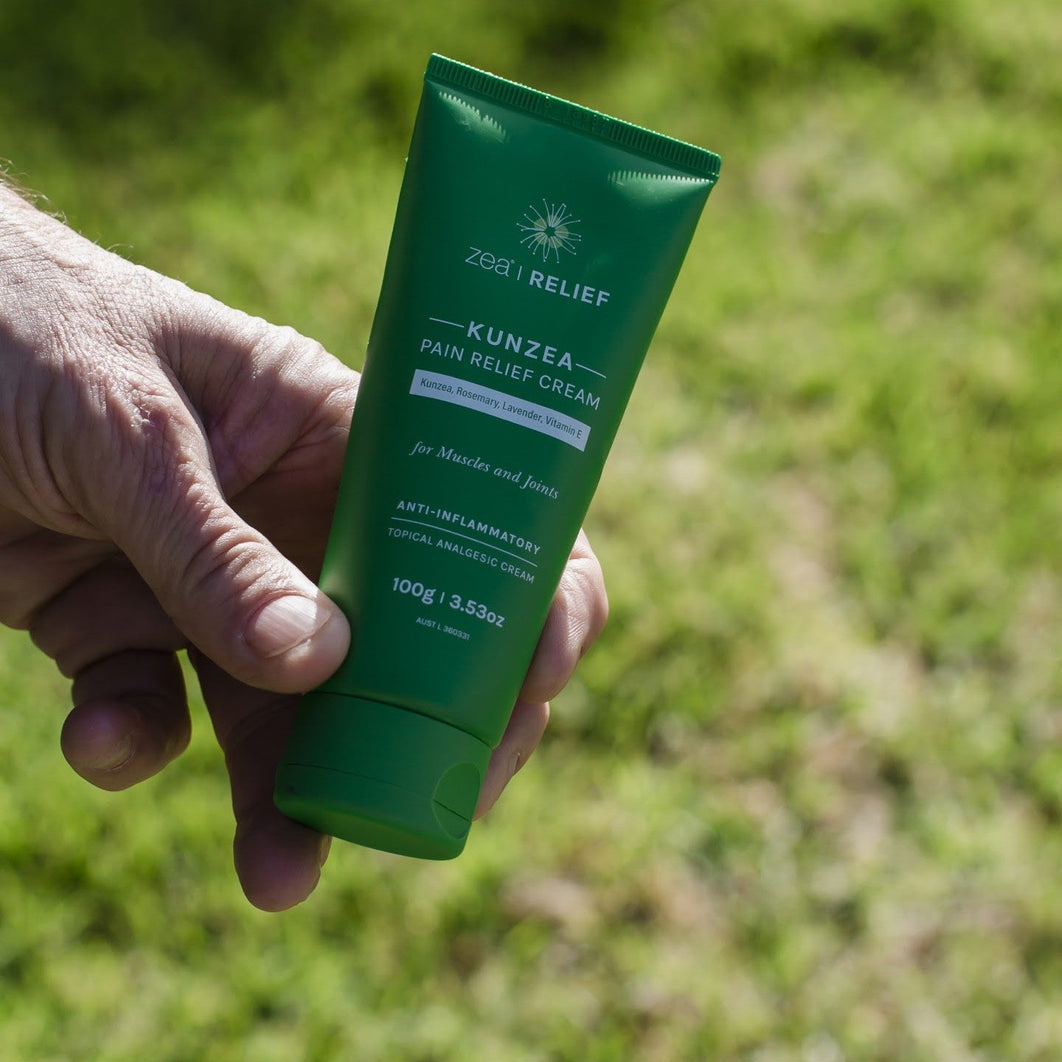 Kunzea Pain Relief Cream held outdoors, used for tennis elbow pain relief